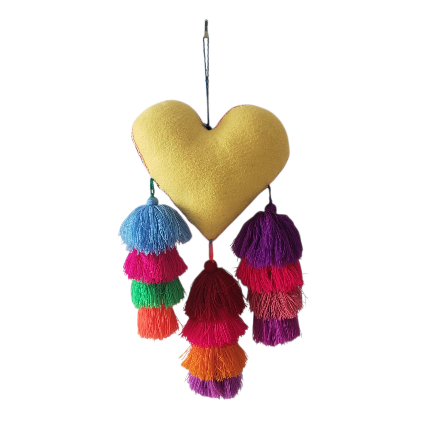 Heart-shaped decorative item with colorful tassels on a white background